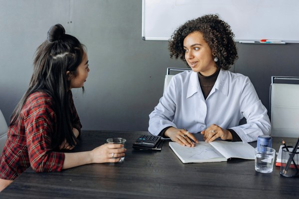 photo of 2 professionals in conversation representing practical application